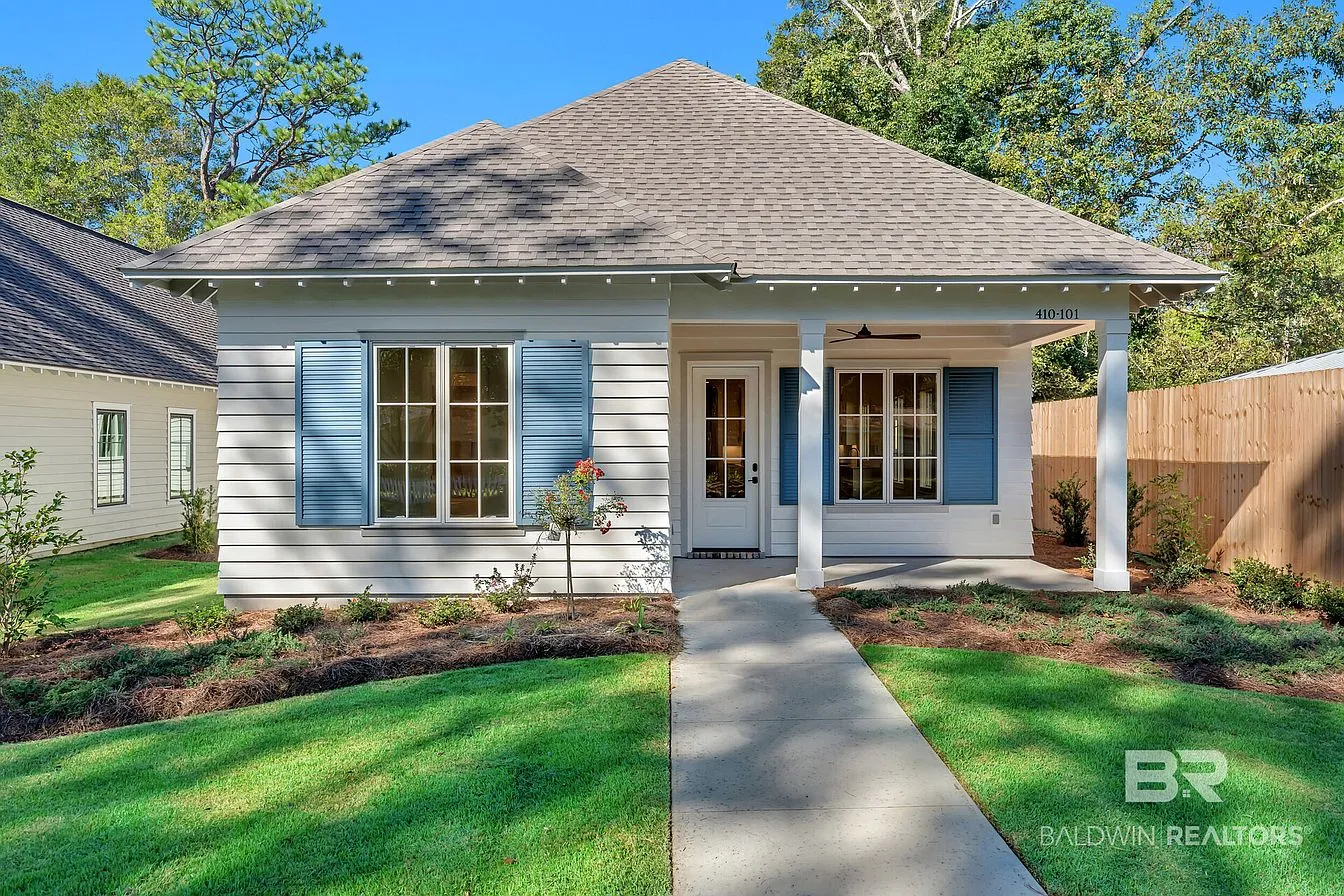 Front exterior with blue shutters and landscaped walkway at 410 Azalea St #101