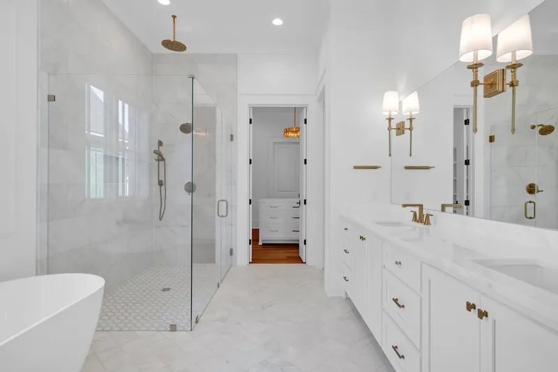Bathroom with a glass-enclosed shower, freestanding tub and long vanity