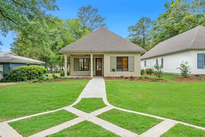 Front view of a cottage with a geometric path across the lawn