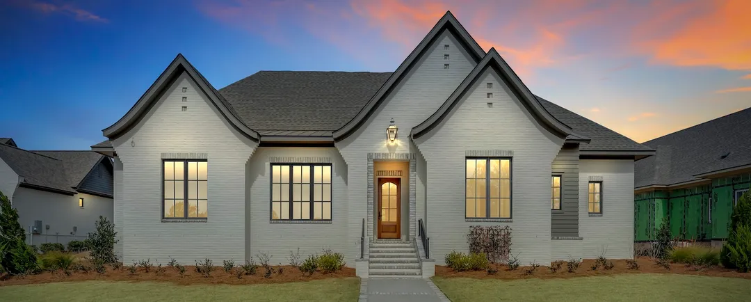 Custom coastal home by Point Clear Building Company at dusk